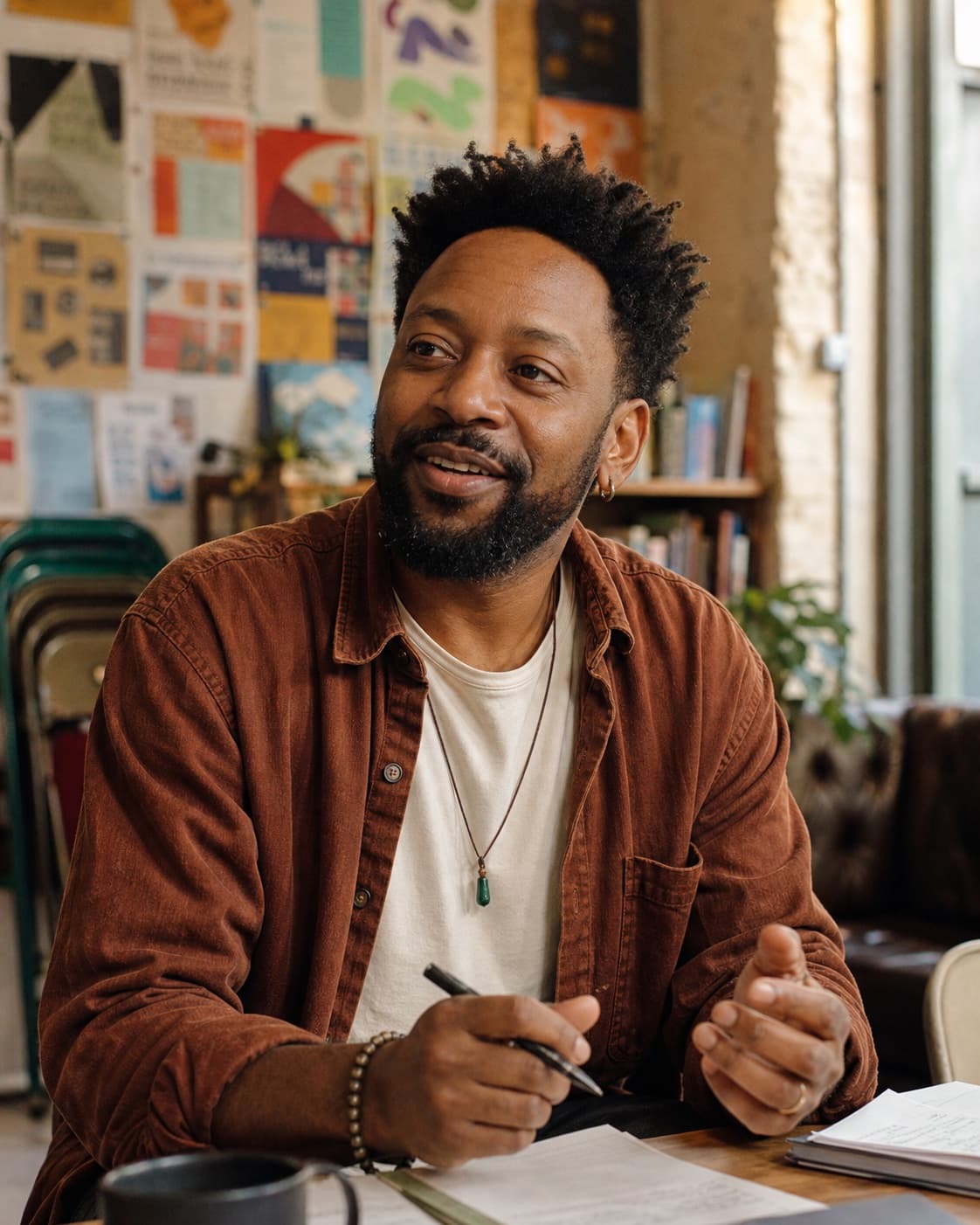 Marcus, a community facilitator, leads a conversation in a neighbourhood arts space.