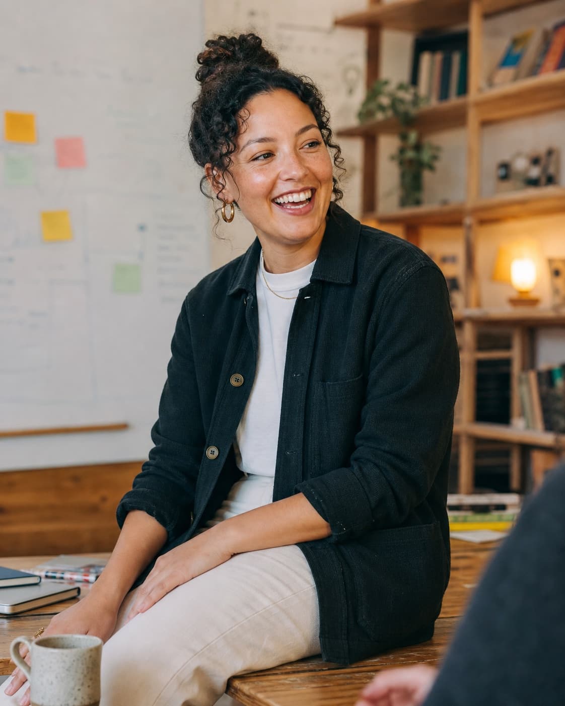 Sophie, a learning and development lead, shares a light moment in a workshop room.